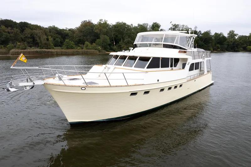 Slide: The Image of Luxurious 2009 Marlow 61C yacht cruising on a serene lake with lush greenery. - 2