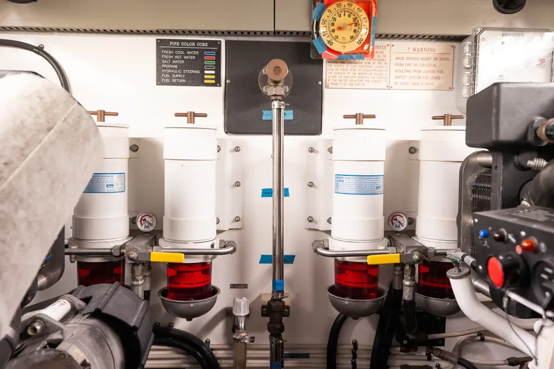 Slide: The Image of Engine room of 2009 Marlow 61C yacht with fuel filters and gauges. - 132