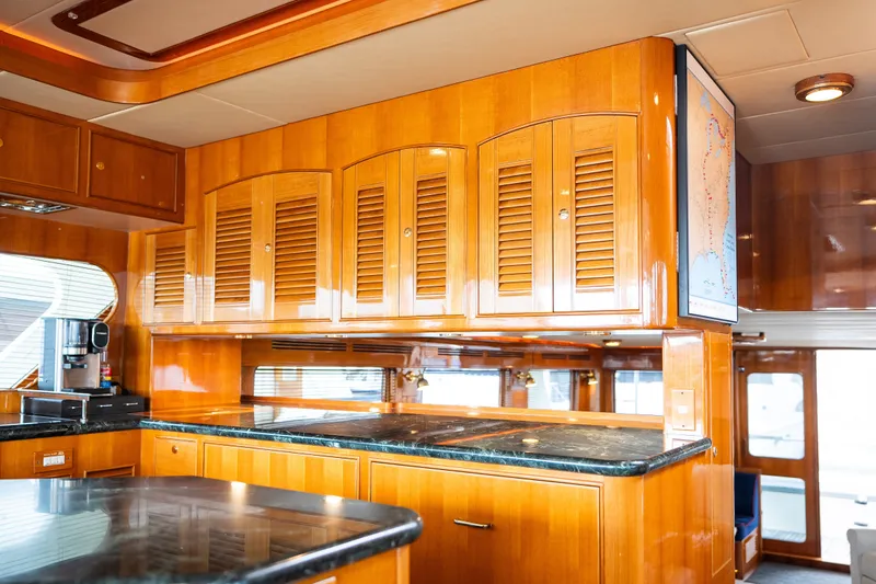 Slide: The Image of Luxurious wooden interior of a 2009 Marlow 61C yacht kitchen with modern appliances. - 64