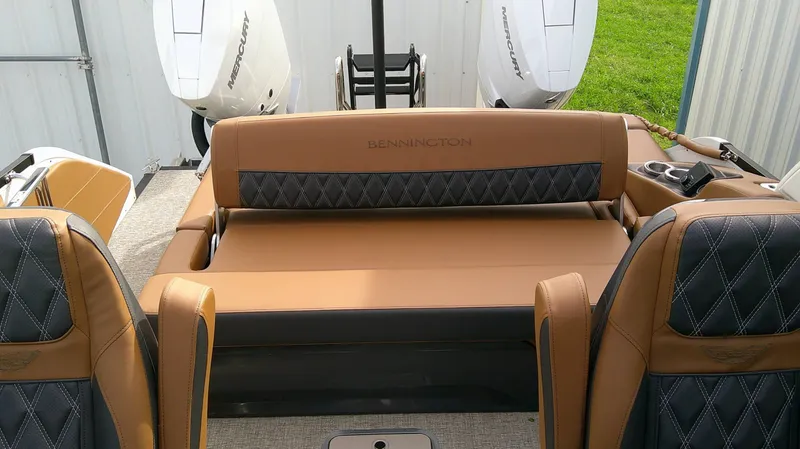 Slide: The Image of The image shows the luxurious interior of a Bennington 27 QXSBA boat with elegant seating. - 16