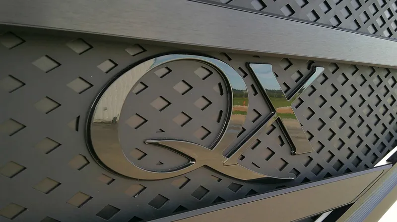 Slide: The Image of Close-up of the "QX" logo on a 2027 Bennington 27 QXSBA. - 6