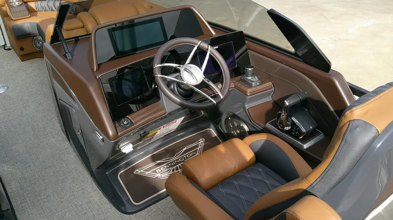 Slide: The Image of The image shows the cockpit of a 2027 Bennington 27 QXSBA boat with a sleek steering wheel and modern instruments. - 9