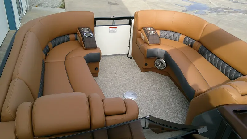 Slide: The Image of The image shows the luxurious, leather-upholstered seating area of a Bennington 27 QXSBA boat. - 8