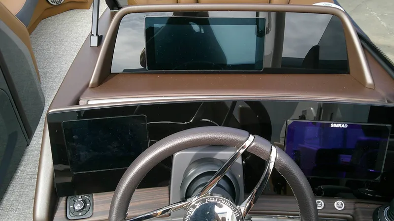Slide: The Image of The image shows the dashboard of a Bennington 27 QXSBA boat with modern instruments. - 10