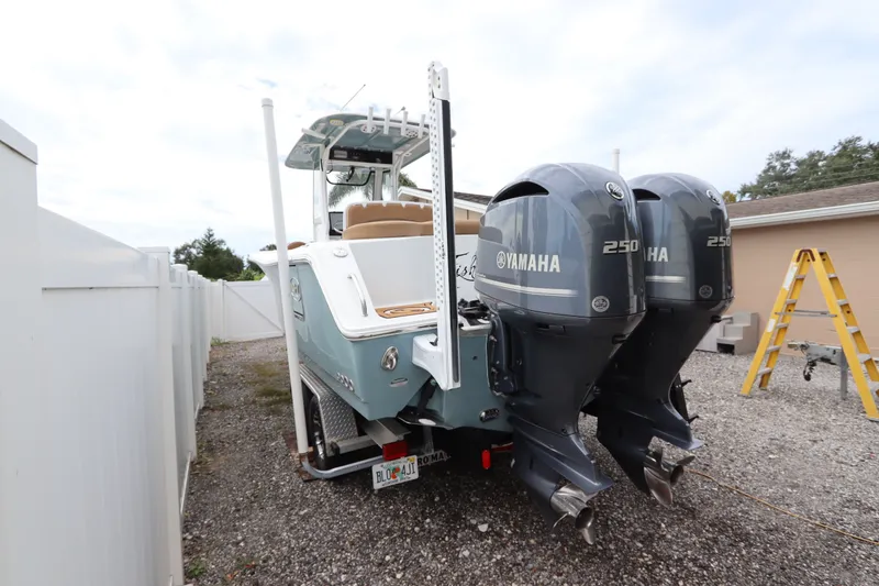 Slide: The Image of 2021 Sea Hunt Ultra 275SE boat with dual Yamaha 250 engines, parked outdoors. - 3