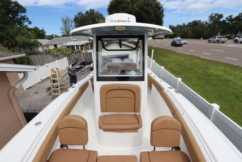 Slide: The Image of 2021 Sea Hunt Ultra 275SE boat with tan seating and Garmin equipment. - 35