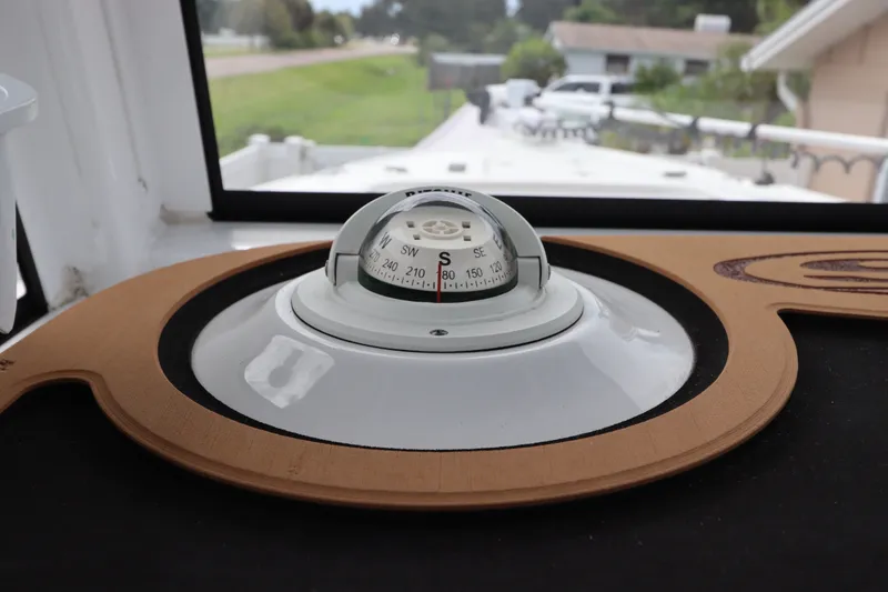 Slide: The Image of Compass on 2021 Sea Hunt Ultra 275SE boat dashboard, showcasing navigation equipment. - 25