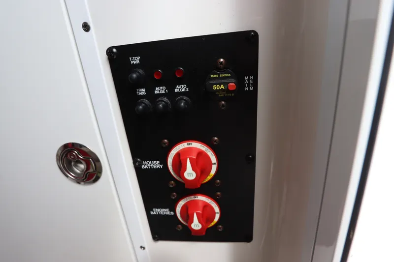 Slide: The Image of Control panel of a 2021 Sea Hunt Ultra 275SE boat with battery switches. - 39