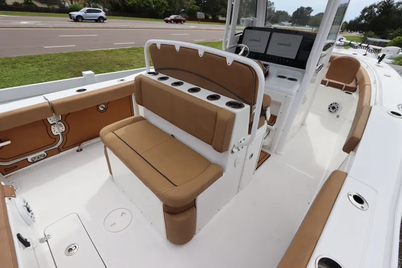Slide: The Image of 2021 Sea Hunt Ultra 275SE boat interior with tan seating and modern dashboard. - 13