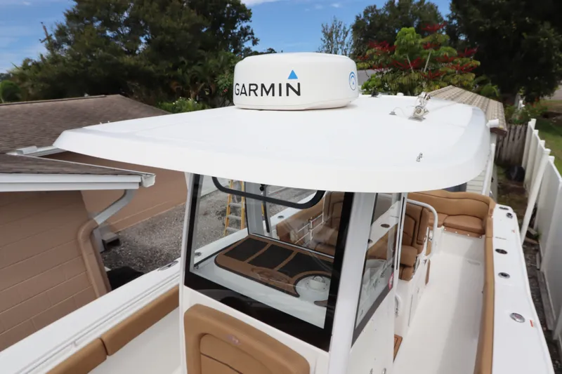 Slide: The Image of 2021 Sea Hunt Ultra 275SE boat with Garmin radar, featuring spacious seating and sleek design. - 36