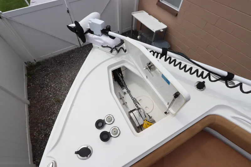 Slide: The Image of 2021 Sea Hunt Ultra 275SE boat anchor compartment with trolling motor and storage. - 33
