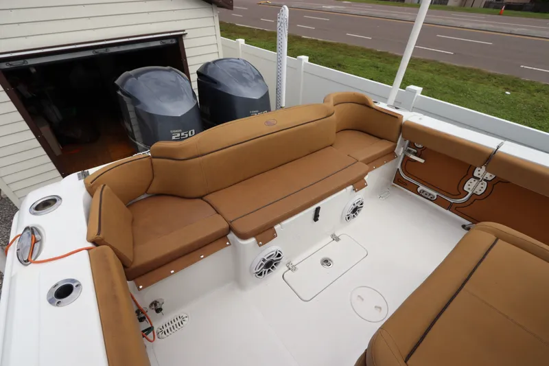 Slide: The Image of 2021 Sea Hunt Ultra 275SE boat interior with tan seating and dual Yamaha 250 engines. - 9
