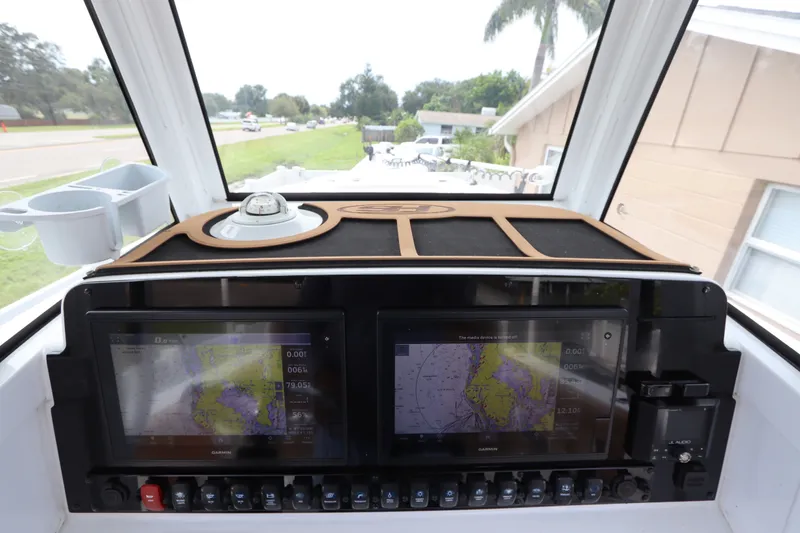 Slide: The Image of Dashboard of 2021 Sea Hunt Ultra 275SE boat with navigation screens and controls. - 24