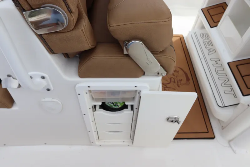 Slide: The Image of 2021 Sea Hunt Ultra 275SE boat interior with storage compartment and cushioned seating. - 17