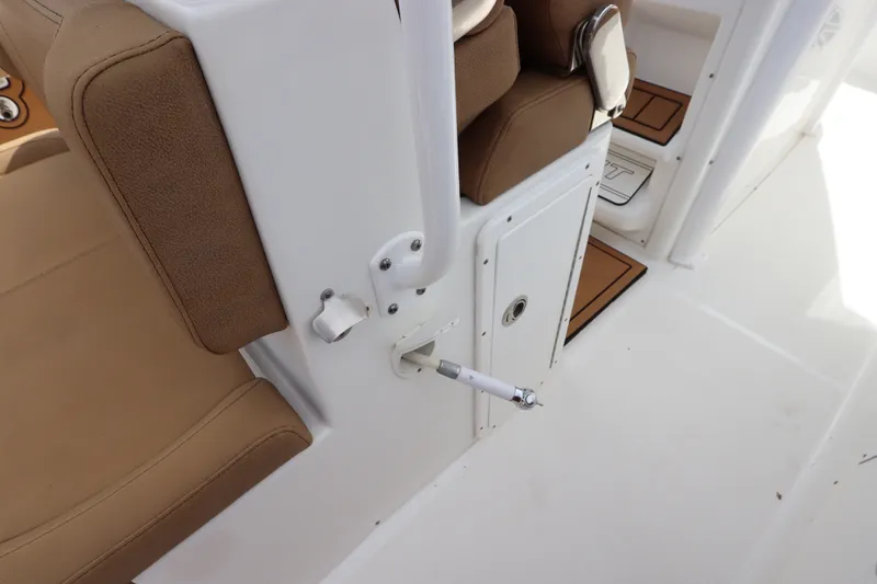 Slide: The Image of Interior view of 2021 Sea Hunt Ultra 275SE boat with tan seating and white panel. - 16