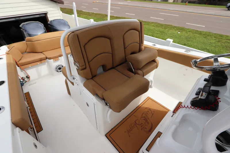Slide: The Image of 2021 Sea Hunt Ultra 275SE boat interior with tan seating and steering console. - 18