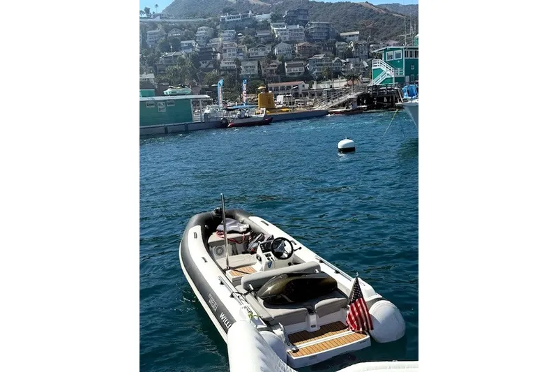 Slide: The Image of 2019 Williams Jet Tenders Sportjet 435 moored in scenic harbor with hillside houses. - 2
