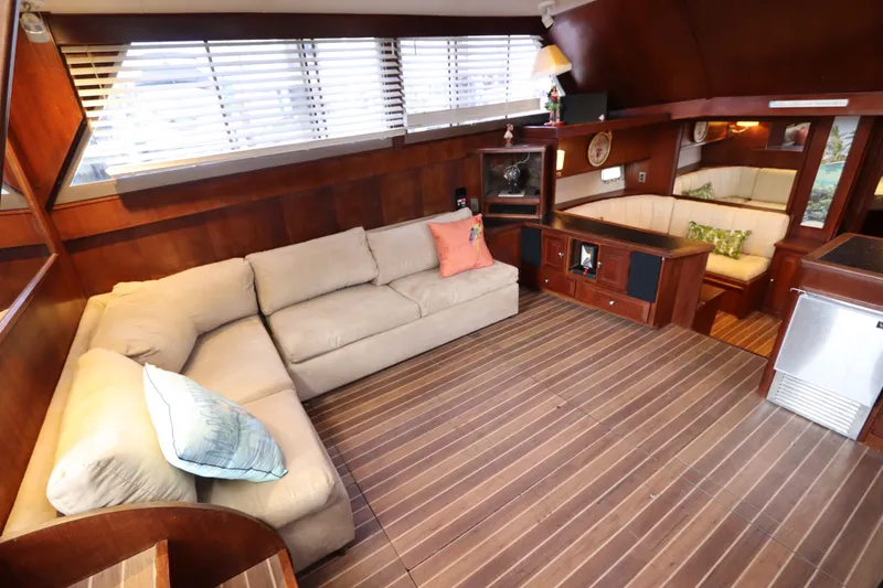 Slide: The Image of Luxurious interior of 1985 Viking 50 Cockpit Motor Yacht with plush seating and wooden accents. - 26