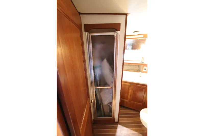Slide: The Image of Interior of 1985 Viking 50 Cockpit Motor Yacht showing shower and wooden cabinetry. - 40