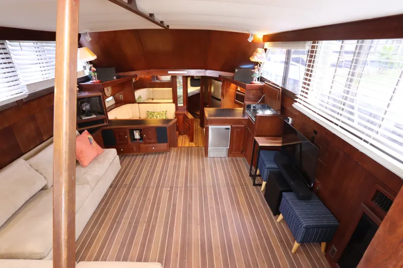 Slide: The Image of Interior of 1985 Viking 50 Cockpit Motor Yacht with wood paneling and cozy seating area. - 23