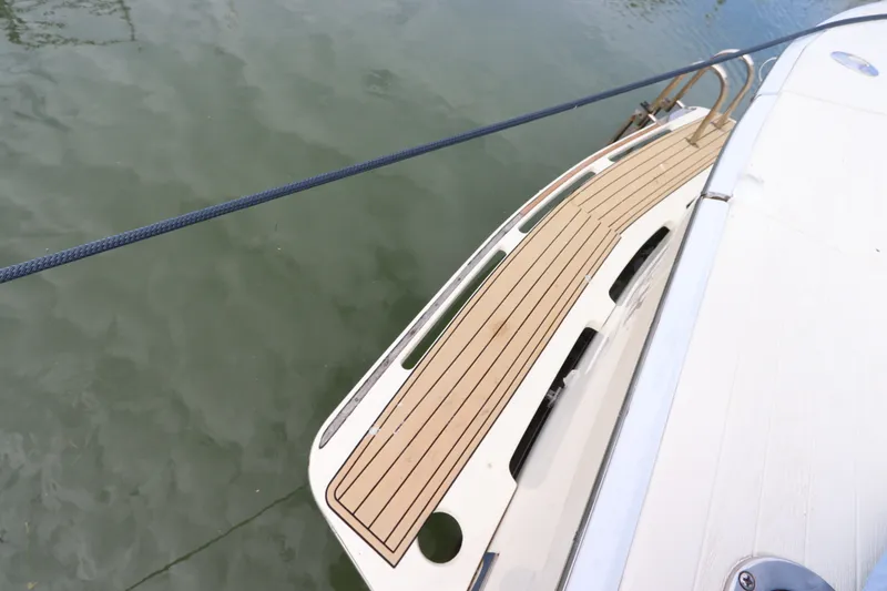 Slide: The Image of 1985 Viking 50 Cockpit Motor Yacht with teak deck, moored on calm water. - 10