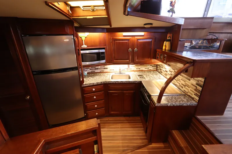 Slide: The Image of Luxurious kitchen interior of 1985 Viking 50 Cockpit Motor Yacht with modern appliances. - 29