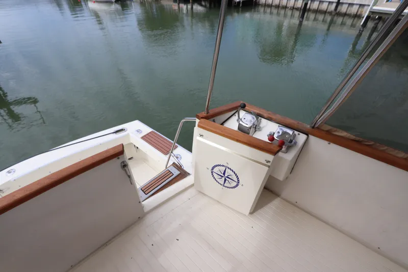 Slide: The Image of 1985 Viking 50 Cockpit Motor Yacht, featuring a spacious cockpit with wooden accents. - 6