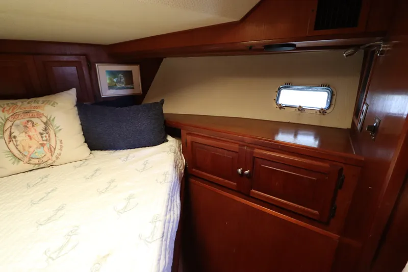Slide: The Image of Cozy cabin interior of 1985 Viking 50 Cockpit Motor Yacht with wooden cabinetry and nautical decor. - 43