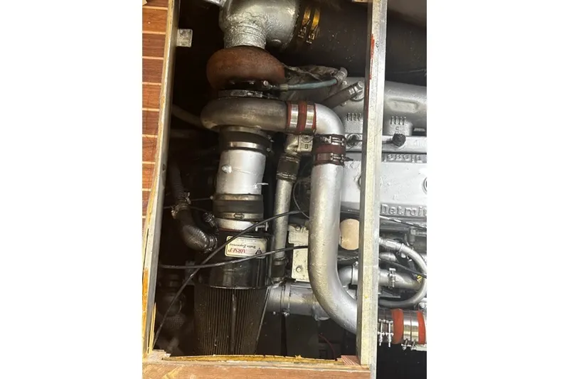 Slide: The Image of Engine compartment of a 1985 Viking 50 Cockpit Motor Yacht, showcasing mechanical components. - 57