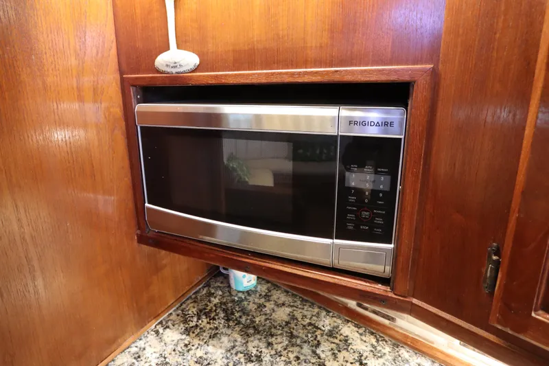 Slide: The Image of Frigidaire microwave in wooden cabinet on 1985 Viking 50 Cockpit Motor Yacht. - 32