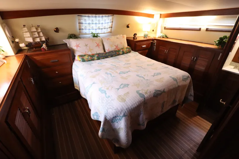 Slide: The Image of Cozy bedroom in 1985 Viking 50 Cockpit Motor Yacht with nautical decor and wooden cabinetry. - 46