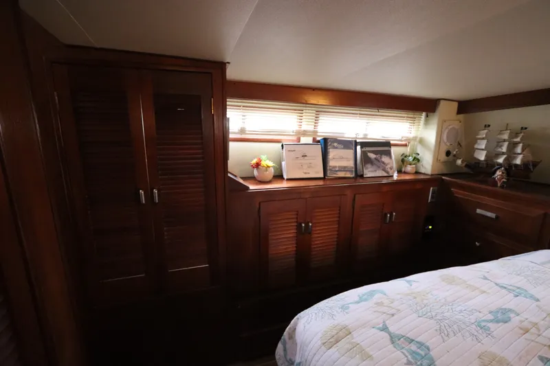 Slide: The Image of Interior of 1985 Viking 50 Cockpit Motor Yacht with wooden cabinets and nautical decor. - 48
