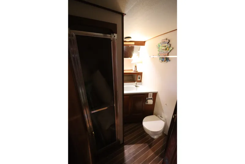 Slide: The Image of Bathroom interior of 1985 Viking 50 Cockpit Motor Yacht with shower and wooden flooring. - 39