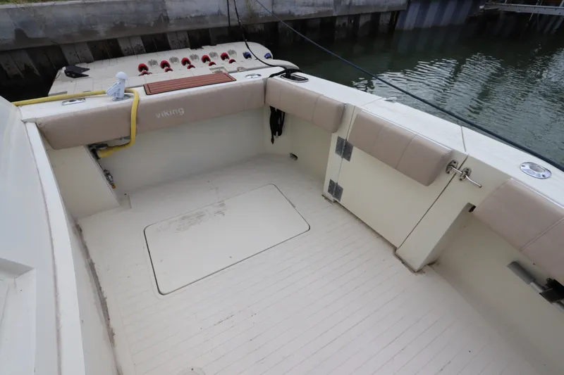 Slide: The Image of 1985 Viking 50 Cockpit Motor Yacht with spacious deck and seating area by the water. - 8