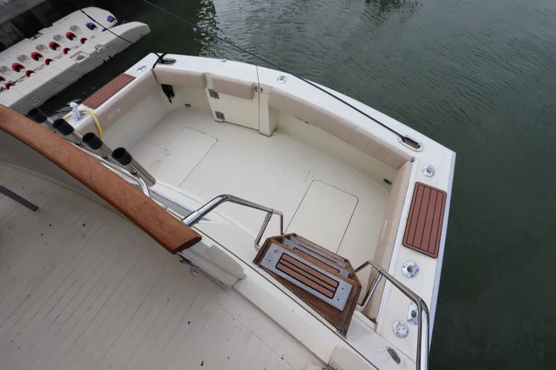 Slide: The Image of Cockpit view of 1985 Viking 50 Cockpit Motor Yacht, featuring spacious seating and wooden accents. - 7