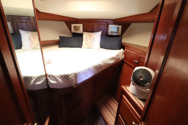 Slide: The Image of Cozy cabin interior of 1985 Viking 50 Cockpit Motor Yacht with wood paneling and bedding. - 42