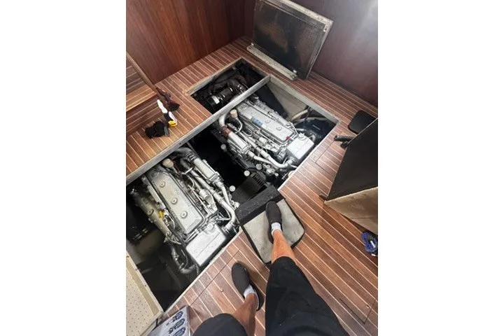 Slide: The Image of Engine room of 1985 Viking 50 Cockpit Motor Yacht with visible twin engines. - 56