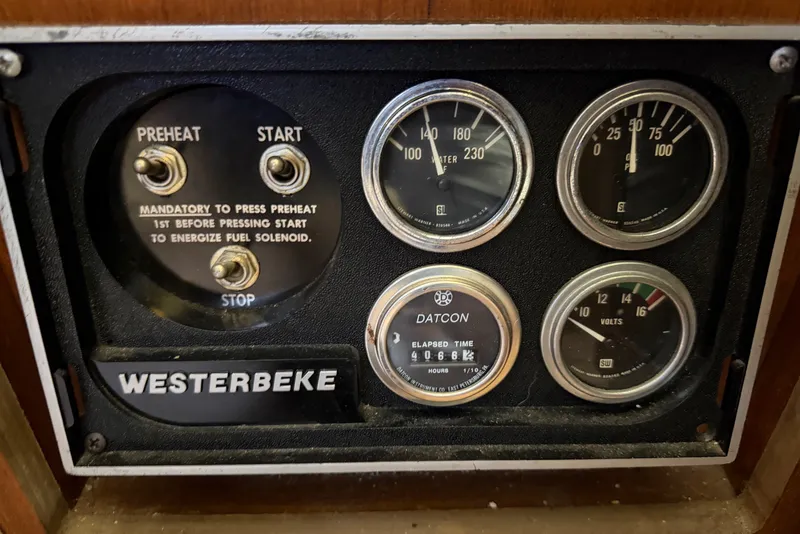 Slide: The Image of Control panel of a 1985 Viking 50 Cockpit Motor Yacht with gauges and switches. - 54