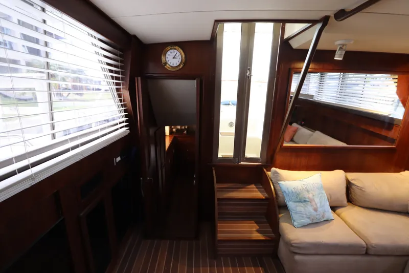 Slide: The Image of Interior of 1985 Viking 50 Cockpit Motor Yacht with cozy seating and wooden accents. - 44