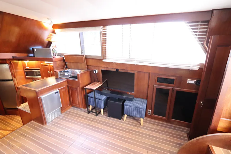Slide: The Image of Interior of 1985 Viking 50 Cockpit Motor Yacht with wood paneling and modern amenities. - 24