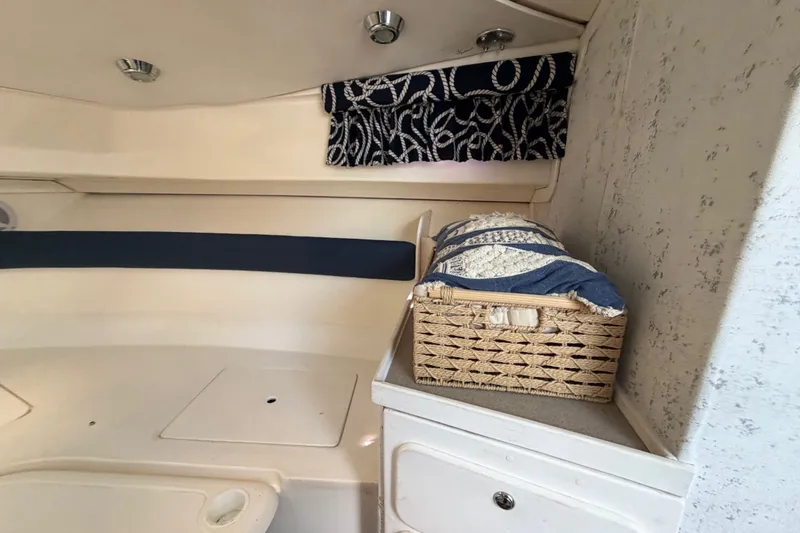 Slide: The Image of Interior of 2003 Stamas 290 Express boat with storage basket and nautical decor. - 16