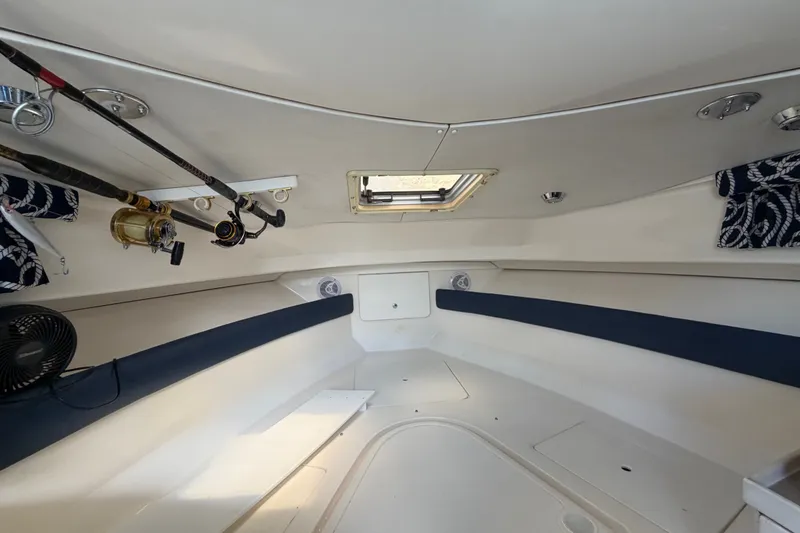 Slide: The Image of Interior cabin of 2003 Stamas 290 Express boat with fishing rods and nautical decor. - 13