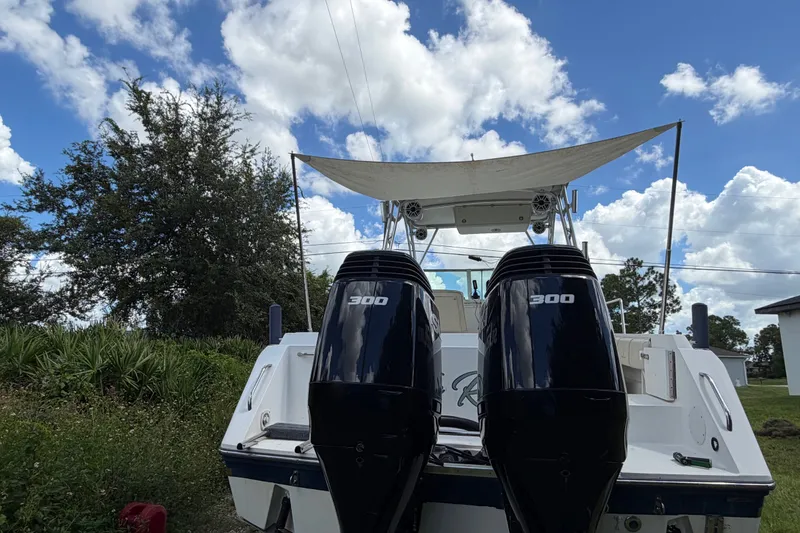 Slide: The Image of 2003 Stamas 290 Express boat with dual 300 horsepower engines, set against a cloudy sky. - 35