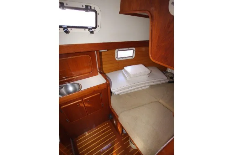 Slide: The Image of 1988 Sceptre 41 yacht cabin interior with wooden finish and compact amenities. - 19