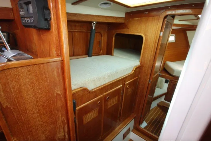 Slide: The Image of Interior of 1988 Sceptre 41 yacht with wooden cabinetry and cozy sleeping area. - 13
