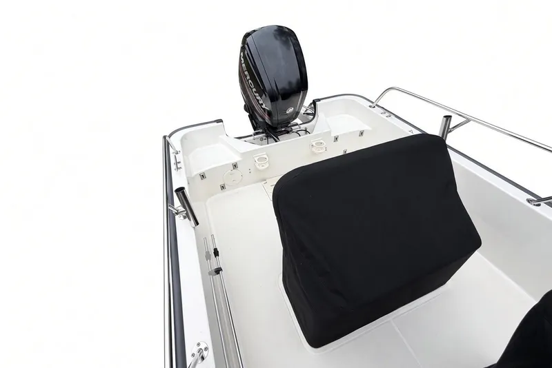 Slide: The Image of 2017 Boston Whaler 170 Montauk boat interior with covered seating and Mercury outboard motor. - 22