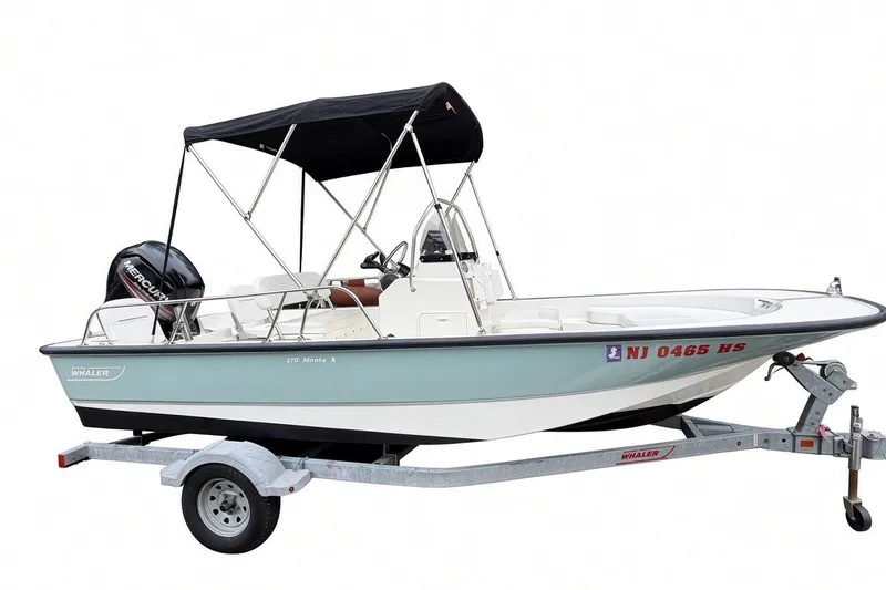 Slide: The Image of 2017 Boston Whaler 170 Montauk boat on trailer with canopy and Mercury engine. - 1
