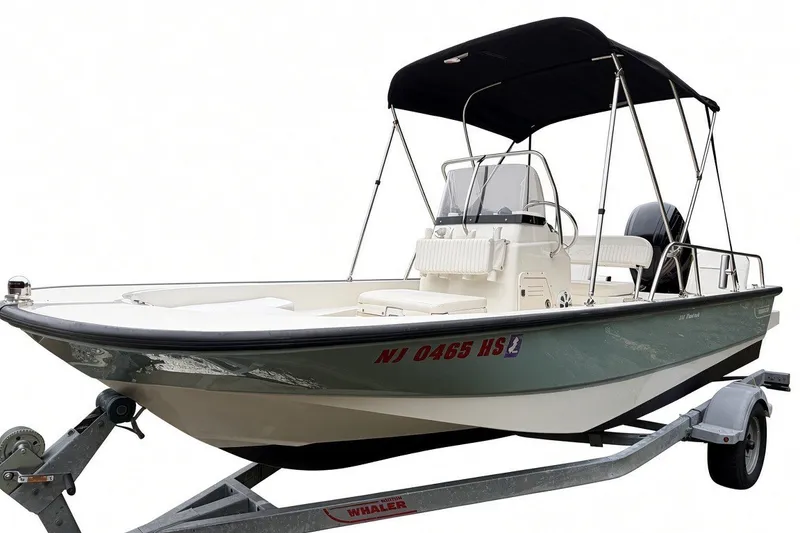 Slide: The Image of 2017 Boston Whaler 170 Montauk boat on trailer with canopy and registration number visible. - 5