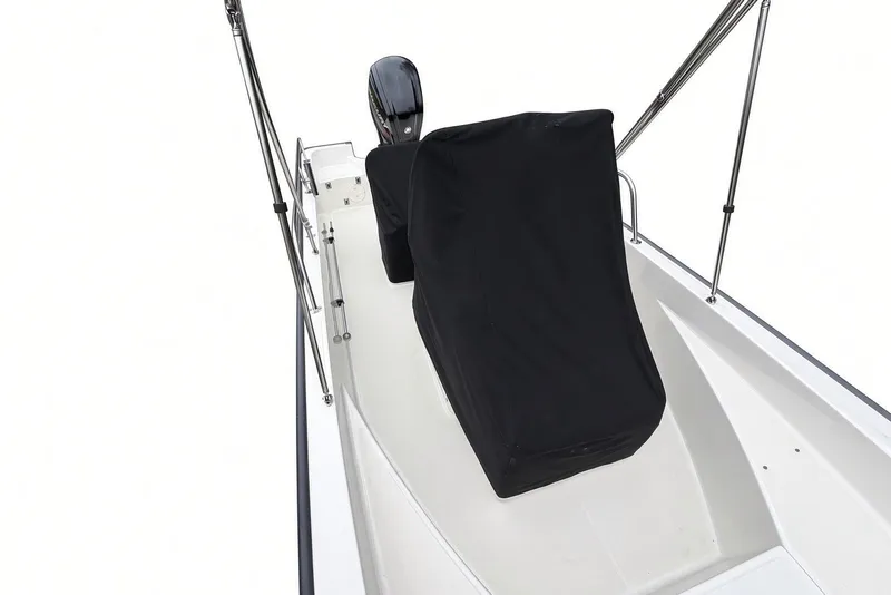 Slide: The Image of 2017 Boston Whaler 170 Montauk boat interior with covered console and motor. - 24