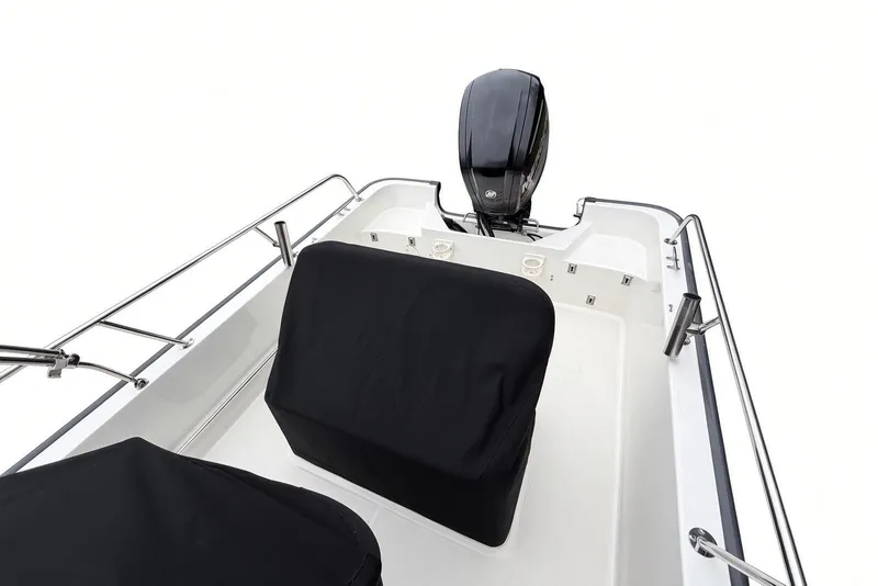 Slide: The Image of 2017 Boston Whaler 170 Montauk boat interior with covered seats and outboard motor. - 23